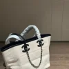 WhatsApp-Image-2026-07-16-at-10.53.10-2-1-44db7a2997a4.webp Chanel Small Tote Canvas, Calfskin & Gold-Tone Metal 45cm/17.7in Ecru & Black AS6285