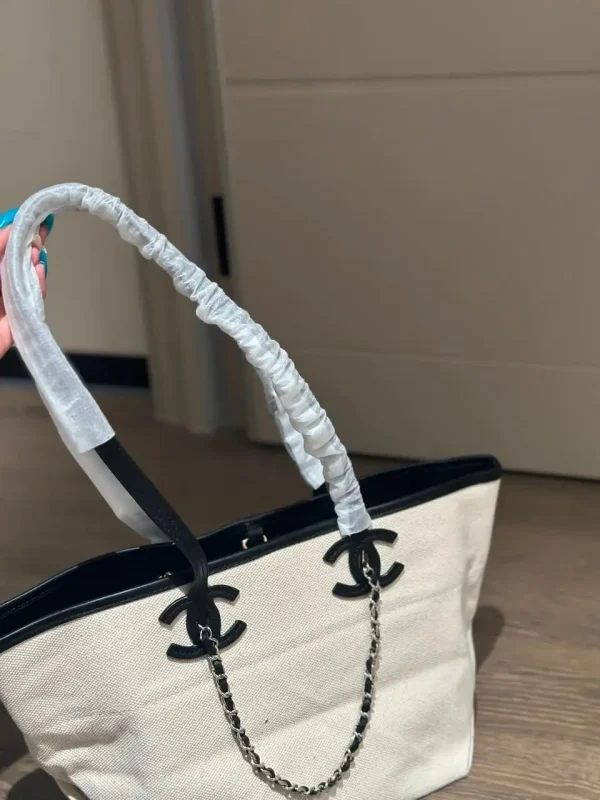 WhatsApp-Image-2026-07-16-at-10.53.11-1-1-41353745fbd3.webp Chanel Small Tote Canvas, Calfskin & Gold-Tone Metal 45cm/17.7in Ecru & Black AS6285