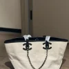 WhatsApp-Image-2026-07-16-at-10.53.11-2-70789f9e9b9b.webp Chanel Small Tote Canvas, Calfskin & Gold-Tone Metal 45cm/17.7in Ecru & Black AS6285