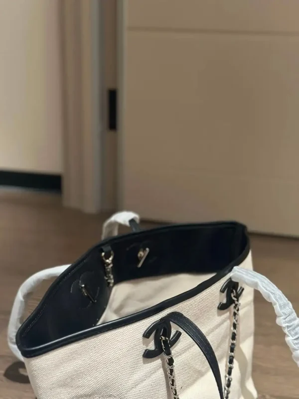 WhatsApp-Image-2026-07-16-at-10.53.12-2-4a05249e07bf.webp Chanel Small Tote Canvas, Calfskin & Gold-Tone Metal 45cm/17.7in Ecru & Black AS6285
